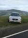 2003 Mercury Marauder - A silver 2003 Mercury Marauder is parked on a grassy hill overlooking a small town.