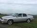 2003 Mercury Marauder - A silver 2003 Mercury Marauder is parked on a grassy incline under a cloudy sky.