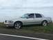 2003 Mercury Marauder - A silver 2003 Mercury Marauder sedan is parked on the side of a road under an overcast sky.