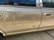 2003 Ford Crown Victoria - Side view of a tan sedan door, chrome trim and a door handle, with visible damage to the lower panel.