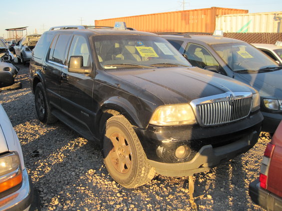Black Lincoln Aviator SUV parked in a lot with other vehicles
