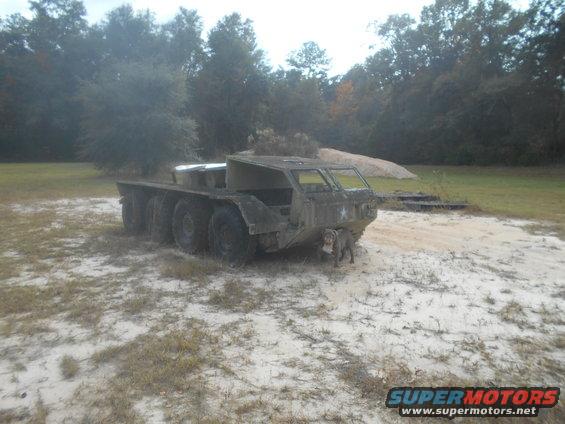 Six-wheeled military truck with a dog in front, 3q-front view