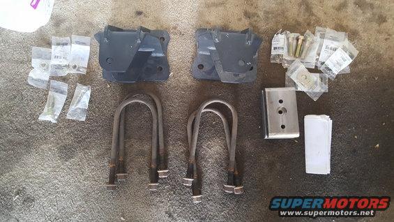Shackle flip kit components including brackets, U-bolts, and hardware