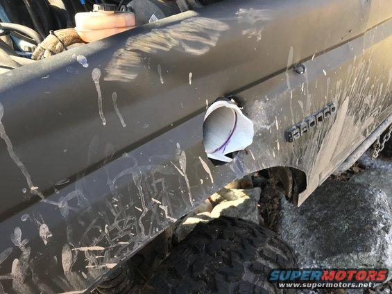 Dark gray 1989 Ford Bronco fender with a hole and "BRONCO" badge