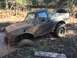 1989 Ford Bronco - Muddy 1989 Ford Bronco navigating an off-road trail and getting stuck in deep mud.