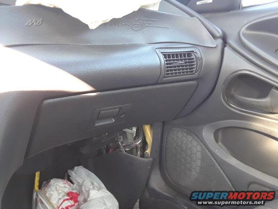 2003 Ford Mustang interior showing dashboard, glove box, and air vent