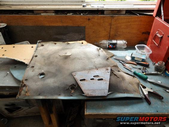 Worn car door panel with metal reinforcement plate