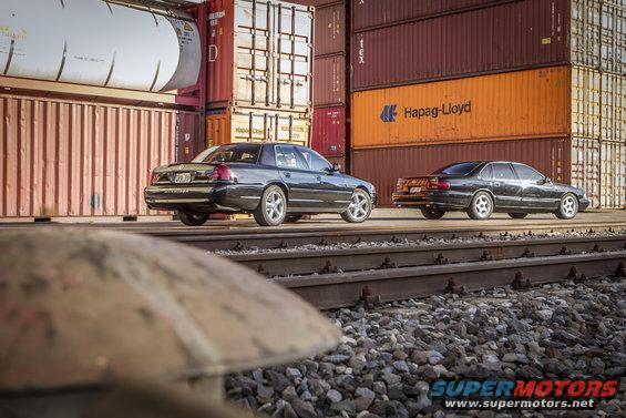 Black 2003 Mercury Marauder parked on train tracks, rear view