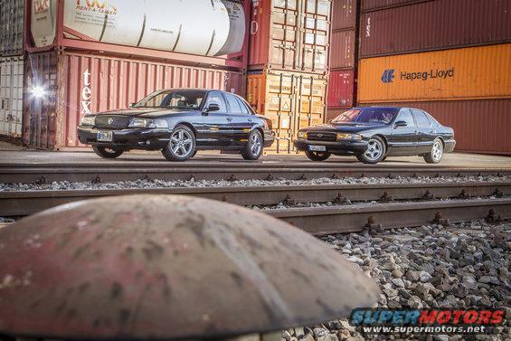 Black 2003 Mercury Marauder parked on train tracks with another sedan