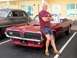 1967 Mercury Cougar - Man poses with a red 1967 Mercury Cougar convertible, with another vintage car in the background.