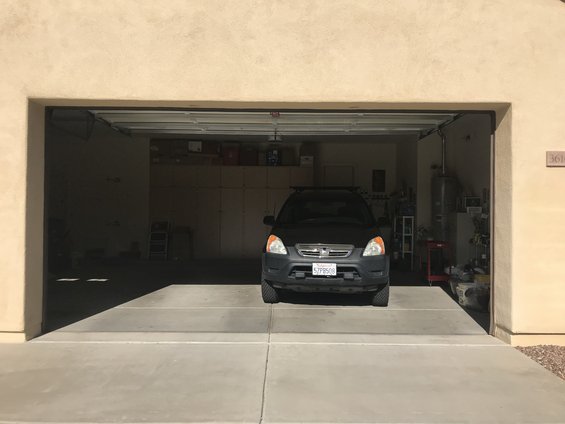 Black SUV parked in a garage, license plate 57PR508