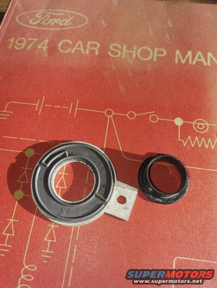 Two automotive parts on a 1974 Ford Car Shop Manual cover