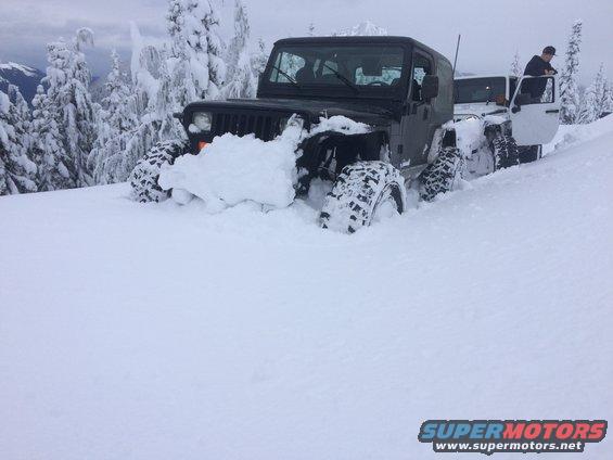 1995 Jeep YJ stuck in deep snow with another Jeep behind it