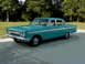 1964 Mercury Comet - Teal 1964 Mercury Comet sedan with horizontal side trim, seen from a 3/4 front angle.