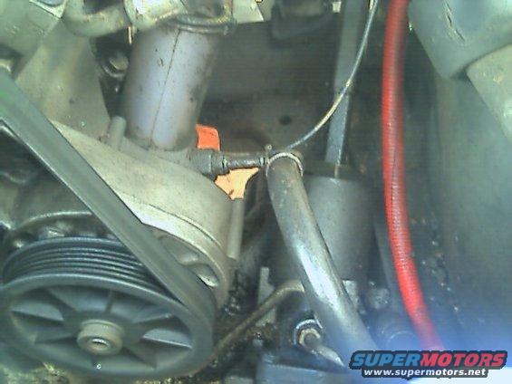 Close-up of engine parts, including a pulley and belt