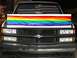 1995 Mercury Grand Marquis - This truck displays a rainbow flag sticker across its hood and an American flag sunshade in the windshield.