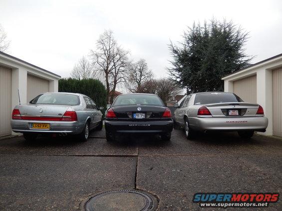 Silver sedan with 'MARAUDER' text on rear, parked between two other sedans