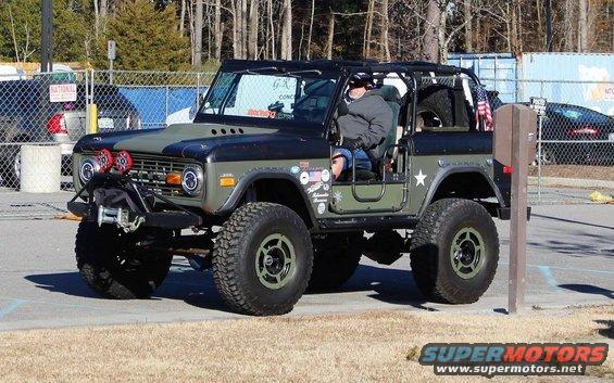 1972 Ford Bronco with custom paint and off-road tires parked outdoors