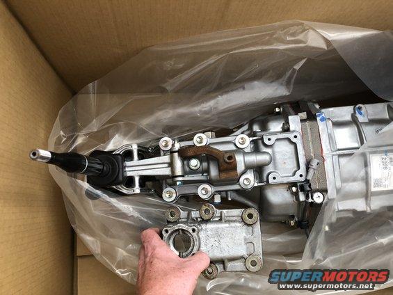 Gearbox assembly with shift lever, partially unwrapped in a cardboard box