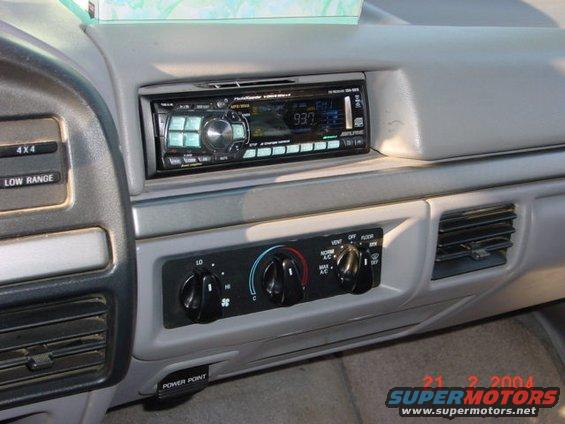Dashboard interior showing an aftermarket radio and climate controls with '4x4' and 'LOW RANGE' labels visible
