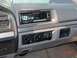 1995 Ford Bronco - Interior view of a vehicle's dashboard, an aftermarket stereo and climate controls.