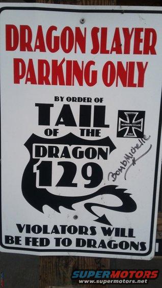 Sign for Dragon Slayer Parking Only, by order of Tail of the Dragon 129. Violators will be fed to dragons