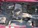 1992 Ford F-150 - The engine bay of a 1992 Ford F-150 is captured in this detailed photograph, highlighting various components.