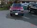 1992 Ford F-150 - A red 1992 Ford F-150 is parked on asphalt, with a black SUV visible to its right.