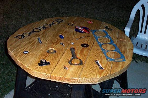 dcp_4246.jpg She cut the table to that shape with a circular saw.  I was very impressed at her skill; she'll do fine if I ever need an emergency amputation.

The white stuff in the holes is wet polyurethane.  It takes about a week for each pouring to dry.