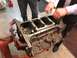 1968 Mercury Cougar - Engine block assembly in progress, with mechanics attending to the internal components.