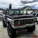 1979 Ford Bronco - This modified Ford Bronco features a lifted suspension and large off-road tires, with a two-tone paint scheme.