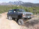 1979 Ford Bronco - This lifted 1978 Ford Bronco navigates a , off-road terrain with snow-capped mountains in the background.