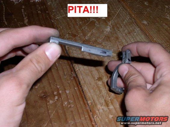 Hands holding a metal car part, with "PITA!!!" text overlay