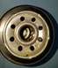 2000 Ford Crown Victoria - Oil filter base showing bolt holes and central threaded opening, with visible dirt and oil residue.