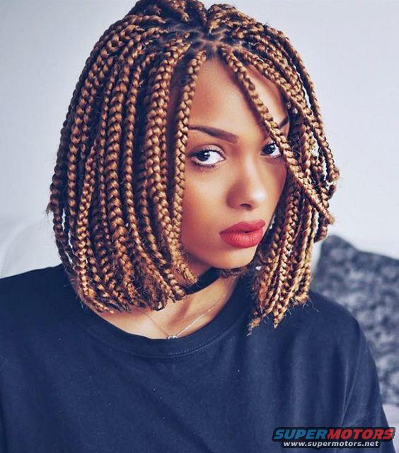 Woman with blonde-brown box braids and red lipstick