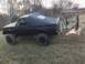 1989 Ford Bronco - This modified Ford Bronco is equipped with a plow attachment, suggesting it's prepared for snow removal or land clearing.