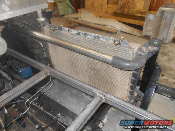 Radiator and metal frame in a workshop, with a tire visible on the left