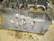 1969 Ford Mustang - Close-up view of an engine block, likely a V8, with oil stains visible on the concrete floor below.