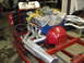 1970 Ford Torino - A V8 engine assembly is shown on a red stand, chrome exhaust headers and a blue engine block.