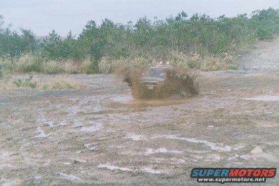 1990 Toyota Tacoma splashing through mud