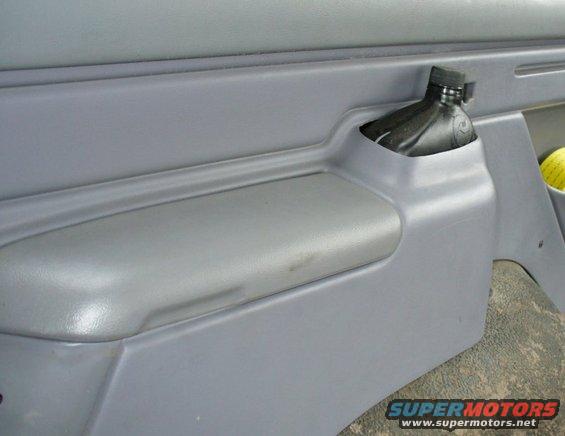 Rear seat belt storage cubby.