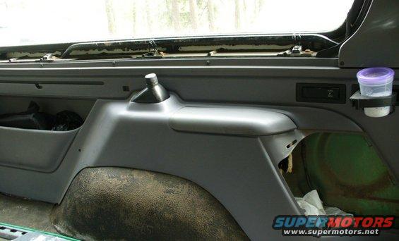 p1040503--rear-seatbelt-storage-cubby.jpg Rear seat belt storage cubby and pry bar mount.