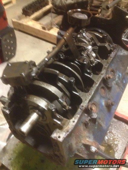 Engine block with crankshaft and oil pan removed, showing internal components