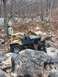 2004 Ford F-150 - A driver navigates a heavily modified Jeep Wrangler through a rocky off-road course.