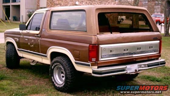Brown 1980 Ford Bronco rear 3/4 view with chrome tailgate panel