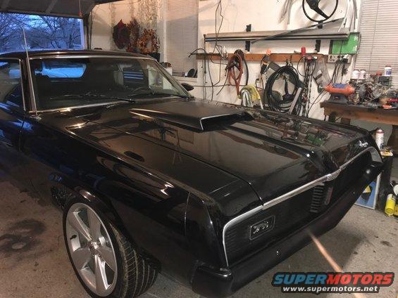 Black 1969 Mercury Cougar with hood scoop and custom wheels