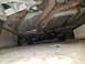 1998 Lincoln Mark VIII - The underside of a car is visible, rusted exhaust pipes and a fuel tank.