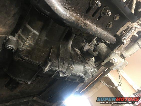 Underside view of a vehicle's transmission housing and related components