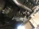 1989 Ford Bronco - Underside view of a vehicle's transmission housing and associated mechanical parts.