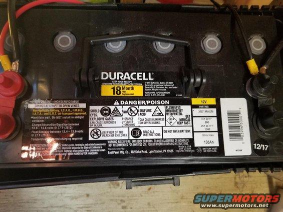 Duracell car battery with 18-month warranty and danger/poison warnings